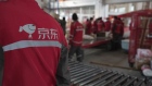 The Jingdong logo on the jacket of a delivery worker at a JD.com sorting center in Beijing, China, on Friday, Oct. 15, 2021. Chinese companies have been investing heavily in warehouses and logistics infrastructure, as the coronavirus pandemic accelerated the shift to e-commerce. Photographer: Gilles Sabrie/Bloomberg