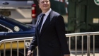 Elon Musk, chief executive officer of Tesla Inc., left, departs court during the SolarCity trial in Wilmington, Delaware, U.S., on Tuesday, July 13, 2021. Musk was cool but combative as he testified in a Delaware courtroom that Tesla's more than $2 billion acquisition of SolarCity in 2016 wasn't a bailout of the struggling solar provider.