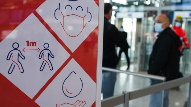 A Coronavirus preventative measures sign in Terminal 3 at Orly Airport, operated by Aeroports de Paris, in Paris, France, on Tuesday, April 27, 2021. Photographer: Nathan Laine/Bloomberg