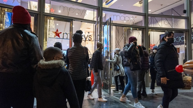 Shoppers exit a Macy's store in San Francisco, California, U.S., on Wednesday, Dec. 22, 2021. Year-over-year retail gains may moderate as shoppers opt to remain home ahead of the holidays amid a surge in Covid-19 omicron cases, and as people stick to pandemic-boosted online-shopping habits. Photographer: David Paul Morris/Bloomberg