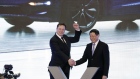 Elon Musk, left, celebrates with Ying Yong, mayor of Shanghai, during the Tesla China-Made Model 3 Delivery Ceremony at the company's Gigafactory in Shanghai, on Jan. 7, 2020. Photographer: Qilai Shen/Bloomberg