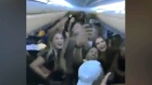 A maskless party on a Sunwing flight is seen in this screengrab.