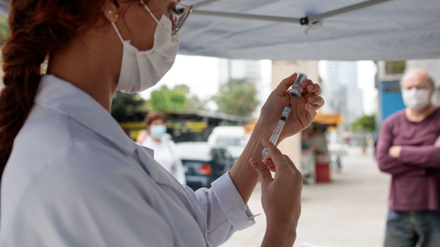 A healthcare worker prepares a dose of the Sinovac Biotech Ltd. Covid-19 vaccine at the Jardim Edite UBS vaccination site in Sao Paulo, Brazil, on Monday, Sept. 6, 2021. Brazil has begun administering third doses of the Covid-19 vaccine, as the Health Ministry says more than 64 million adults have received two doses or the single dose of the vaccine.