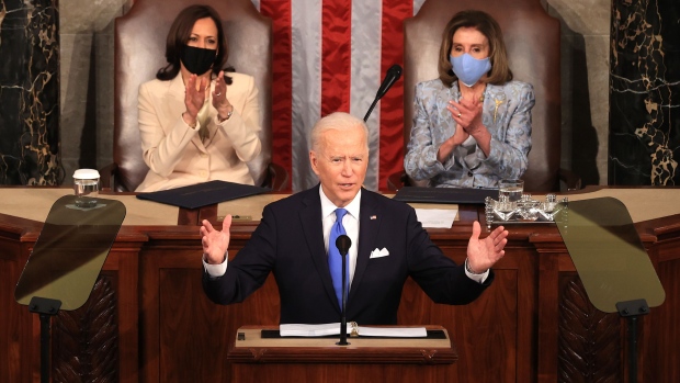 U.S. President Joe Biden, center, speaks during a joint session of Congress at the U.S. Capitol with U.S. House Speaker Nancy Pelosi, a Democrat from California, right, and U.S. Vice President Kamala Harris in Washington, D.C., U.S., on Wednesday, April 28, 2021. Biden will unveil a sweeping $1.8 trillion plan to expand educational opportunities and child care for families, funded in part by the largest tax increases on wealthy Americans in decades, the centerpiece of his first address to a joint session of Congress tonight.