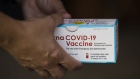 A healthcare worker holds a box of Moderna Covid-19 vaccine vials at a pop up vaccination site at Hammons Field in Springfield, Missouri, U.S., on Tuesday, Aug. 3, 2021. Some of the most vaccine-resistant parts of the U.S. are now leading the country in the number of people getting a first dose of vaccine, a Bloomberg analysis shows, as surging infections and rising hospitalizations push formerly reluctant Americans to protect themselves. Photographer: Angus Mordant/Bloomberg