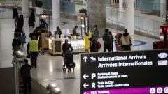 Travelers at Toronto Pearson International Airport. Photographer: Cole Burston/Bloomberg