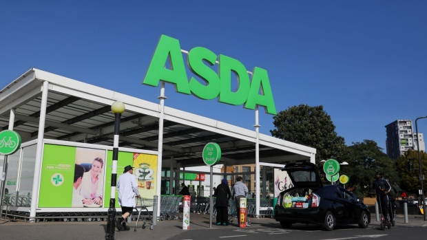 Customers enter an Asda supermarket, operated by Walmart Inc., in London, U.K., on Monday, Sept. 28, 2020. Walmart Inc. has picked a consortium backed by TDR Capital as the preferred bidder for a majority stake in its U.K. grocery unit Asda, people with knowledge of the matter said. Photographer: Simon Dawson/Bloomberg