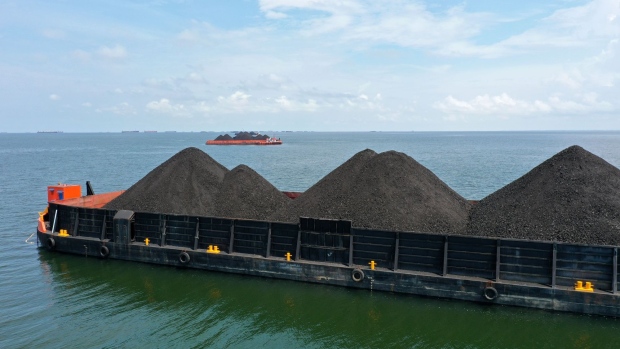 A barge loaded with coal anchored offshore in Muara Berau, Indonesia, in October.