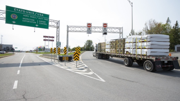 A truck approaches the Canada-U.S. border in Saint-Bernard-de-Lacolle, Quebec, Canada, on Wednesday, Sept. 16, 2020. The U.S. and Canada will extend restrictions on travel across the border until at least Oct. 21, CBC News reported, citing a person with direct knowledge of the situation. Photographer: Christinne Muschi/Bloomberg