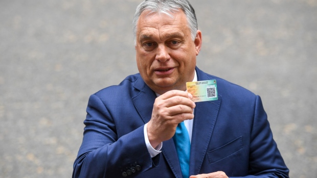 Viktor Orban, Hungary's prime minister, holds his Covid-19 vaccination card as he speaks to member of the media outside number 10 Downing Street, following his bilateral meeting with Boris Johnson, U.K. prime minister, in London, U.K., on Friday, May 28, 2021. Johnson's meeting with Orban, is one of the British leader's first in-person meetings with a European Union leader since Brexit and the coronavirus pandemic. Photographer: Chris J. Ratcliffe/Bloomberg