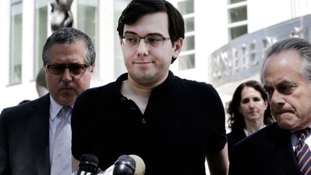 Martin Shkreli, former chief executive officer of Turing Pharmaceuticals AG, center, pauses while speak to members of the media with his attorney Benjamin Brafman, right, outside federal court in the Brooklyn borough of New York, U.S., on Friday, Aug. 4, 2017. Shkreli, notorious for raising the price of a potentially life-saving drug by 5,000 percent, was found guilty Friday of defrauding investors in two hedge funds and in Retrophin Inc., a pharmaceutical company he co-founded. Shkreli was convicted of three of eight charges, including securities fraud.