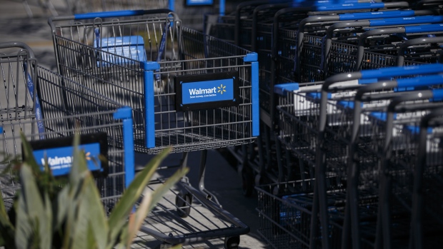 The Wal-Mart Stores Inc. logo is displayed on shopping carts outside the company's location in Burbank, California, U.S., on Tuesday, Nov. 22, 2016. Consumer hardline retailers are hopeful Black Friday will provide a strong start to the holiday shopping season, but any lift may come at the expense of margins, as the landscape has become increasingly promotional. Photographer: Patrick T. Fallon/Bloomberg