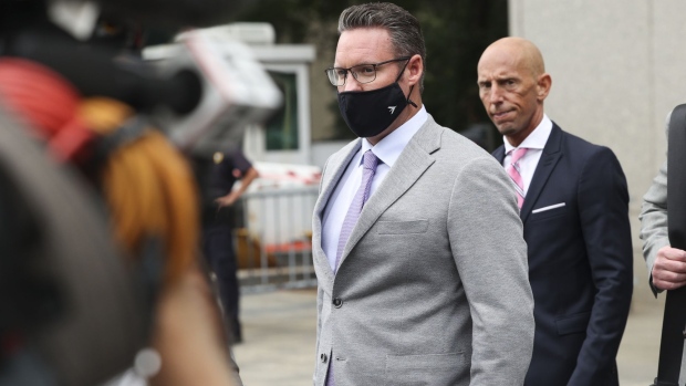Trevor Milton, founder of Nikola Corp., center, exits federal court in New York, U.S., on Thursday, July 29, 2021. Milton is charged with misleading investors from November 2019 until around September 2020 about the development of Nikola’s products and technology, according to an indictment unsealed Thursday by federal prosecutors in N.Y.