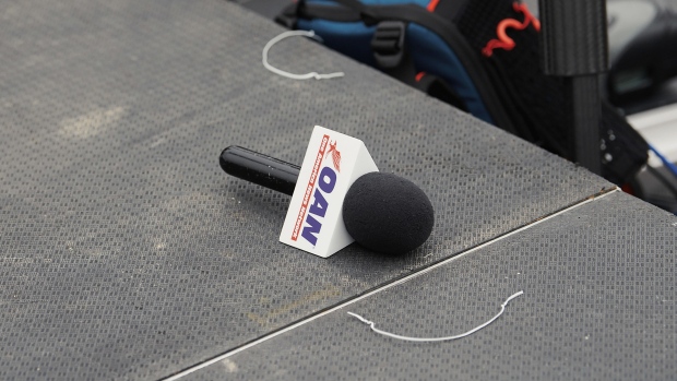 A One America News Network (OAN) microphone on the media risers during a Save America rally with former U.S. President Donald Trump at the Iowa State Fairgrounds in Des Moines, Iowa, U.S., on Saturday, Oct. 9, 2021. Trump has been hinting about another presidential bid, even as he has tried to steer clear of activities that would trigger federal election laws that would require him to register as a candidate -- and limit spending.