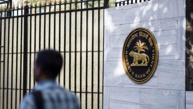 A pedestrian walks past the Reserve Bank of India (RBI) building in Mumbai, India, on Tuesday, March 3, 2020. India's central bank governor said he's ready to act to shield the economy from the coronavirus and reiterated there's room to cut interest rates if needed.