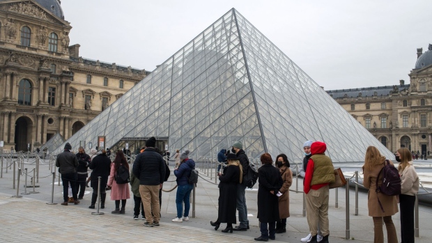 Visitors wait in line for access to the Louvre Museum in Paris, France, on Wednesday, Jan. 12, 2022. The pandemic in France has become a live political issue as authorities are struggling to contain the spread of the omicron variant and new infections hit a record.