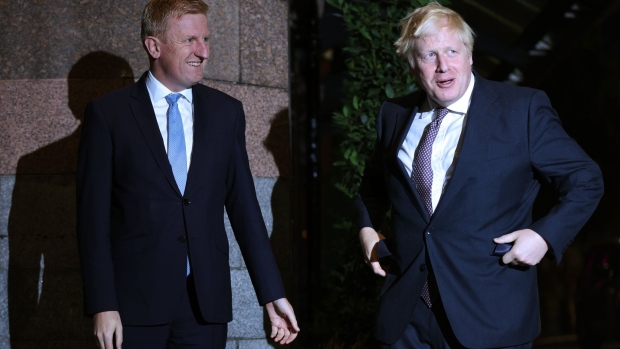 Oliver Dowden, co-chairman of the Conservative Party, left, greets Boris Johnson, U.K. prime minister, ahead of the annual Conservative Party conference in Manchester, U.K., on Saturday, Oct. 2, 2021. In a quirk of timing, the Conservative conference is bookended by the phasing out of two major support measures credited with staving off an unemployment crisis and limiting the numbers falling into poverty during the pandemic.