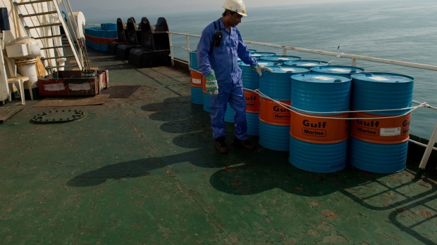 A crew man secures Gulf Marine oil drums on the deck of oil tanker 'Devon' as it prepares to transport crude oil from Kharq Island to India in Bandar Abbas, Iran, on Friday, March 23, 2018. Geopolitical risk is creeping back into the crude oil market. Photographer: Ali Mohammadi/Bloomberg