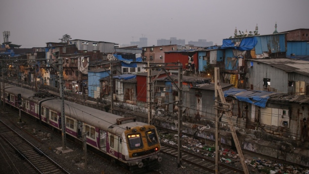 A train passes the Dharavi area of Mumbai, India, on Wednesday, Jan. 5, 2022. Official economic estimates due Friday are expected to forecast an expansion of 9.5%, compared with a 7.3% contraction last year as the government enforced strict restrictions to contain the pandemic.