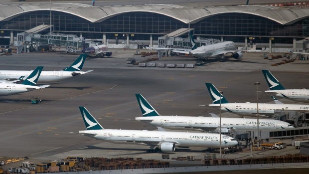 Aircraft operated by Cathay Pacific Airways Ltd. on the tarmac at Hong Kong International Airport in Hong Kong, China, on Thursday, Jan. 6, 2022. Hong Kong is imposing strict new virus control measures for the first time in almost a year as the highly transmissible omicron variant seeps into the community and threatens to spur a winter wave. Photographer: Paul Yeung/Bloomberg