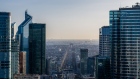 The Arc de Triomphe monument, center, at the end of Champs Elysee avenue on the city skyline beyond the Electricite de France SA (EDF) headquarters, right, and other skyscrapers in the La Defense business district in Paris, France, on Wednesday, Jan. 5, 2022. French President Emmanuel Macron took Europe’s aggressive stance against the unvaccinated up a notch, saying he wants to “p--- off” people who don’t get their Covid-19 shot.