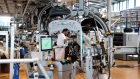 A worker secures fittings under the hood of a Volkswagen AG (VW) ID.3 electric automobile on the assembly line at the automaker's factory in Dresden, Germany, on Tuesday, June 8, 2021. VW's supervisory board is proposing to investors to extend the contract of Chairman Hans Dieter Poetsch and board member Louise Kiesling for another term of five years at the next annual meeting, a spokesman said. Photographer: Liesa Johannssen-Koppitz/Bloomberg