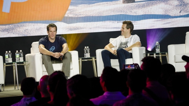 Tyler Winklevoss, chief executive officer and co-founder of Gemini Trust Co., left, and Cameron Winklevoss, president and co-founder of Gemini Trust Co., speak during the Bitcoin 2021 conference in Miami, Florida, U.S., on Friday, June 4, 2021. The biggest Bitcoin event in the world brings a sold-out crowd of 12,000 attendees and thousands more to Miami for a two-day conference.