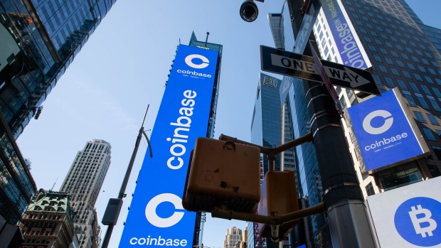 Monitors display Coinbase signage during the company's initial public offering (IPO) at the Nasdaq MarketSite in New York. Photographer: Michael Nagle/Bloomberg