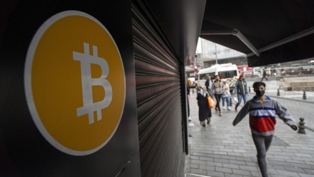 A bitcoin logo outside a closed cryptocurrency exchange kiosk in Istanbul, Turkey, on Monday, Nov. 8, 2021. Bitcoin and Ether hit all-time highs in a cryptocurrency rally that some analysts attributed partly to the search for a hedge against inflation. Photographer: Moe Zoyari/Bloomberg