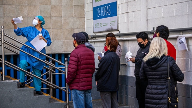 A healthcare worker delivers Covid-19 test results in Mexico City, Mexico, on Thursday, Jan 6, 2022. Mexico's Covid-19 cases soared past 15,000 for the first time since September as the omicron variant spread, but the country’s stockpile of unused vaccines stood near 50 million and jabs slowed to a crawl over the holiday season.