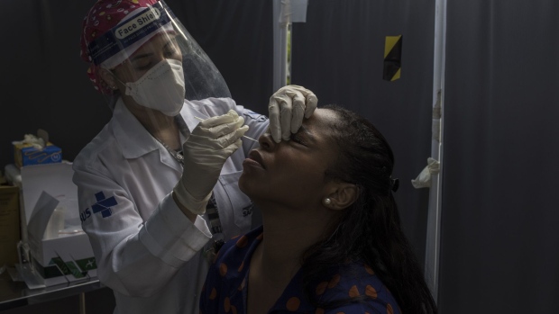 A resident receives a Covid-19 swab test at a testing and vaccination site in Sao Paulo, Brazil, on Friday, Jan. 14, 2022. Brazil reported the biggest one-day increase in cases since Sept. 18, with 112,286 new cases in 24 hours.
