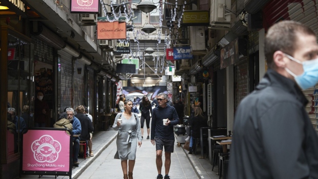 Shoppers walk past stores on Degraves Street in Melbourne, Australia, on Sunday, Nov. 7, 2021. Australian retailers suffered their worst quarter of sales on record as coronavirus-induced lockdowns along the nations heavily populated east coast slashed spending, underscoring expectations the economy contracted in the period. Photographer: James Bugg/Bloomberg