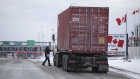 A driver heads back to their truck after stopping at Canadian Customs heading towards the U.S. at the border in St-Bernard-de-Lacolle, Quebec, Canada, on Friday, Jan. 14, 2021. Canada plans to start turning away unvaccinated U.S. truckers at the border this weekend, a move that threatens to upend the flow of everything from food to auto parts to building supplies between two of the world's largest trading partners.