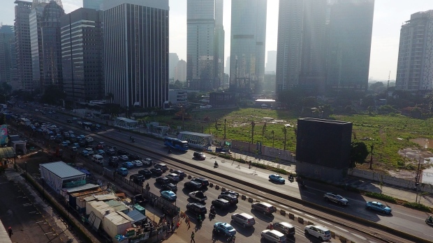 Vehicles travel along a road as commercial buildings stand in this aerial photograph taken in Jakarta, Indonesia, on Thursday, Jan. 31, 2019. Indonesia is scheduled to release fourth-quarter gross domestic product (GDP) figures on Feb. 6. Photographer: Dimas Ardian/Bloomberg
