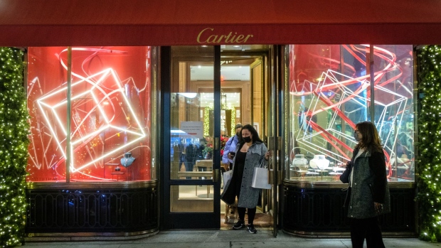 A customer exits from the Cartier jewelry store on Fifth Avenue in New York, U.S., on Thursday, Dec. 2, 2021. U.S. retail sales strengthened from Nov. 3-23, rising 15.5% as an earlier holiday push and Black Friday deals, and concern over product shortages, may have pulled forward demand.