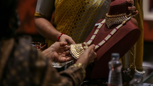A customer looks at a gold necklace inside a Titan Co. Tanishq jewelry store during the festival of Dhanteras in Mumbai, India, on Tuesday, Nov. 2, 2021. Indians flocked to jewelry stores on the biggest gold-buying day of the year, with a bumper sales period for precious metals that culminates in the festival of Diwali expected for the first time since the pandemic began. Photographer: Dhiraj Singh/Bloomberg