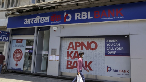 A pedestrian wearing a protective mask walks past an RBL Bank Ltd. branch on a near-empty street in Mumbai, India, on Monday, May 4, 2020. India's central bank Governor Shaktikanta Das and the chief executive officers of the nation's banks have discussed ways to ensure credit flow to businesses once the world's toughest stay-at-home order ends.