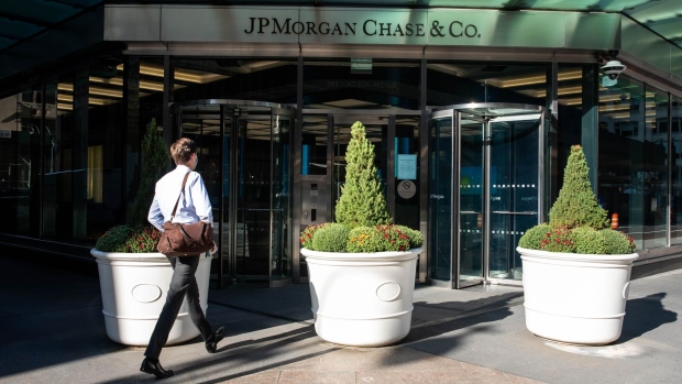 A person walk towards JPMorgan Chase & Co. headquarters in New York, U.S., on Monday, Sept. 21, 2020. JPMorgan CEO Dimon has made the case for a broader return, saying his firm has seen "alienation" among younger workers and that an extended stretch of working from home could bring long-term economic and social damage. Photographer: Michael Nagle/Bloomberg