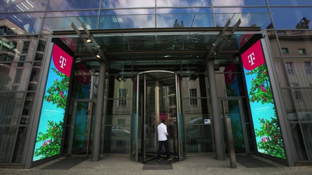 A visitor arrives at the Deutsche Telekom AG offices in Berlin, Germany, on Tuesday, Aug. 10, 2021. Deutsche Telekom reports second quarter earnings on Aug. 12.