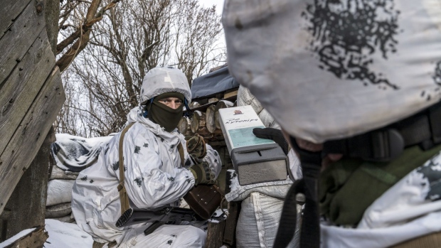 PISKY, UKRAINE - JANUARY 18: Yura (L) and Viktor, Ukrainian soldiers with the 56th Brigade in a trench on the front line on January 18, 2022 in Pisky, Ukraine. Negotiations last week between Russian and Western diplomats, who were hoping to defuse the prospect of a Russian invasion of Ukraine, ended inconclusively. In recent months, Russia has amassed forces and military equipment near the Ukrainian border, raising the specter of a possible invasion of the country's east, where separatists have waged a nearly 8-year war against the Ukrainian government. (Photo by Brendan Hoffman/Getty Images)