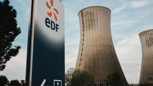 A logo near the cooling towers of the Tricastin Evolutionary Power Reactor (EPR) nuclear power plant, operated by Electricite de France SA (EDF), in Saint-Paul-Trois-Chateaux, France, on Sunday, May 9, 2021. EDF reports first quarter earnings on May 12. Photographer: Theo Giacometti/Bloomberg