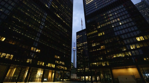 Office towers light up in the evening in the financial district of Toronto, Ontario, Canada, on Friday, May 22, 2020. Whether the PATH, a subterranean network that provides connections between major commuter stations, over 80 properties, including the headquarters of Canada's five largest banks, and 1,200 retail spots, can return to its glory days will depend initially on how quickly Bay St. firms return workers to their offices.