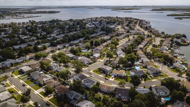 Homes stand in an aerial photograph taken over Merrick, New York, U.S., on Monday, Aug. 26, 2019. Few markets are more copacetic to flippers right now than Long Island, whose 2.8 million residents live in a range of socio-economic groupings, from traffic-clogged commuter communities to lunch-pail fishing towns to the opulent beach hamlets of the Hamptons.