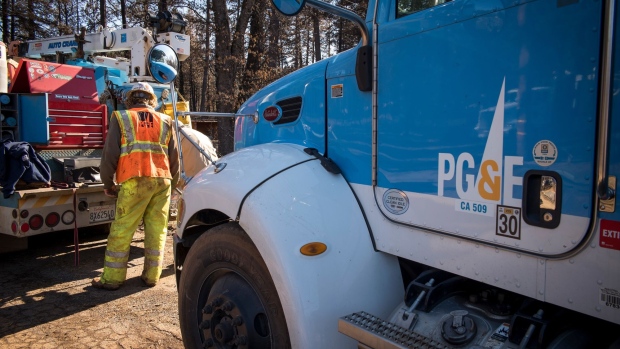 A Pacific Gas & Electric Co. (PG&E) employee works in Paradise, California, U.S., on Tuesday, Jan. 22, 2019. PG&E Co., California's biggest utility owner, faces $30 billion in potential wildfire liabilities, and its bankruptcy plan has reverberated across the power industry. The states big utilities have seen their shares plunge since November's deadly Camp Fire, and PG&E's debt rating has been cut to junk status.