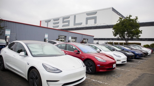 Tesla Inc. electric vehicles charge at the Tesla Supercharger station in Fremont, California, U.S., on Monday, July 20, 2020. Tesla Inc. is scheduled to release earnings figures on July 22. Photographer: Nina Riggio/Bloomberg