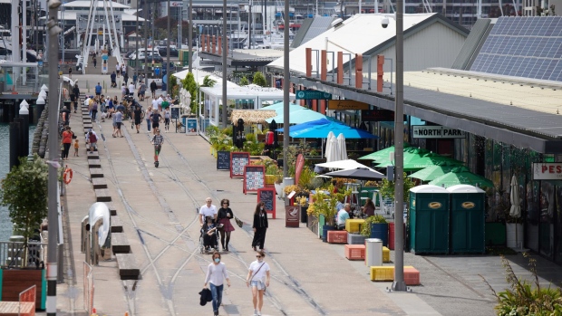 Pedestrians walk past cafes and restaurants in Auckland, New Zealand, on Sunday, Dec. 5, 2021. New Zealand’s largest city has exited lockdown, bringing relief to its residents but also signaling the likely spread of Covid-19 to the rest of the country.