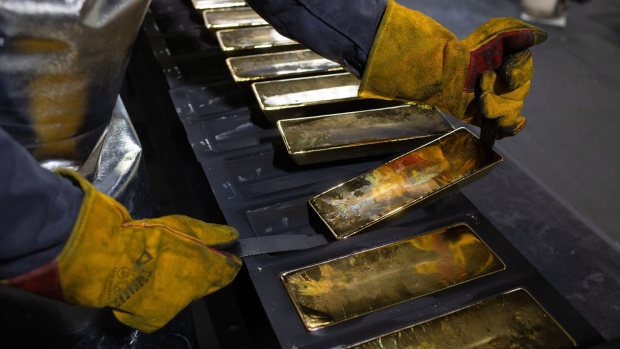 A worker removes cooled 12 kilogram gold ingots from their molds in the foundry at the Prioksky non-ferrous metals plant in Kasimov, Russia, on Thursday, Dec. 9, 2021. Bullion is heading for its first annual drop in three years as central banks start to dial back on pandemic-era stimulus. Photographer: Andrey Rudakov/Bloomberg