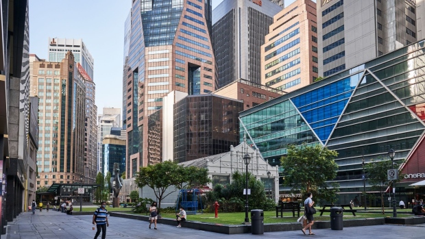 Pedestrians pass through a near empty Raffles Place in the central business district (CBD) of Singapore, on Tuesday, Sept. 28, 2021. Singapore’s Finance Minister Lawrence Wong said earlier this week that the country is committed to reopening, and that recently reimposed curbs are to ensure the health system can handle an increased number of daily cases. Photographer: Lauryn Ishak/Bloomberg
