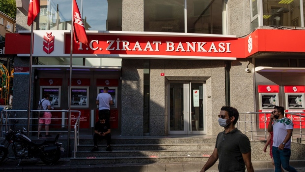 Pedestrians pass a bank branch of TC Ziraat Bankasi AS in Istanbul, Turkey, on Thursday, Aug. 27, 2020. Economic activity fell faster and deeper in emerging markets than in advanced economies as the Covid-19 shock hit, and the recovery is proving slower and shallower.