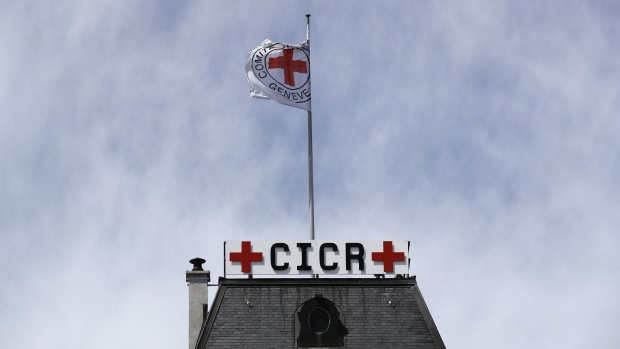 A flag flies on top of the headquarters of the International Committee of the Red Cross (ICRC) in Geneva, Switzerland, on Tuesday, May 14, 2019. While the Swiss city has largely recovered from the end of secrecy at financial institutions, which shrank the number of banks there by a quarter since 2005, it faces questions about its allure for international businesses and the world’s wealthy. Photographer: Stefan Wermuth/Bloomberg